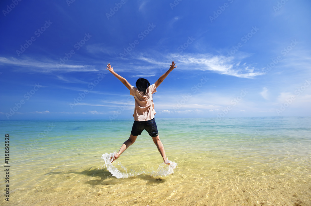 Young girl jumping in the sea