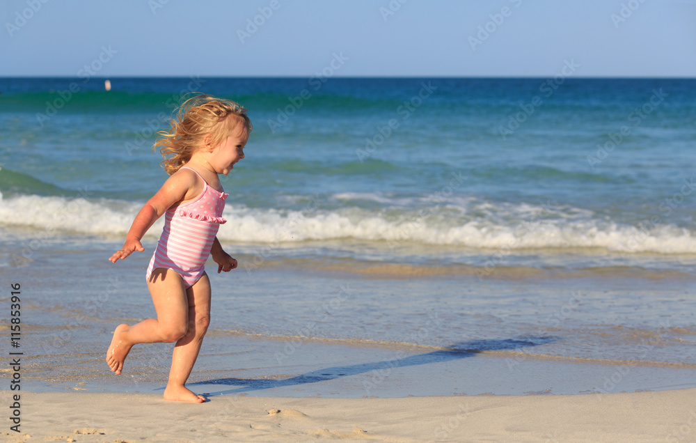 happy child running and jumping in the waves at beach happy child running and jumping in the waves at beach