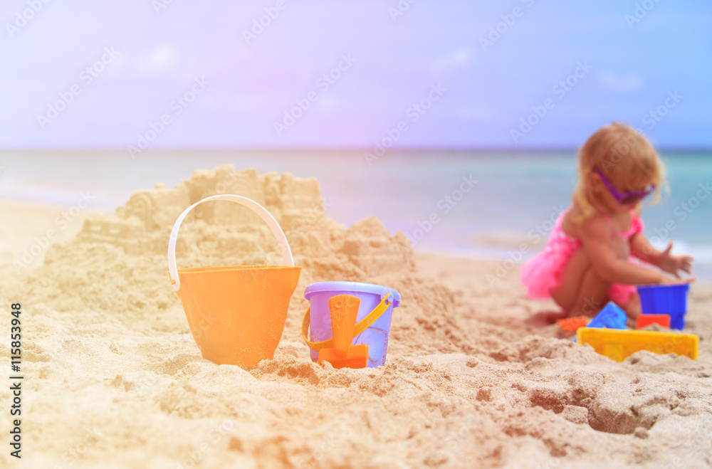 kids toys and little girl building sandcastle kids toys and little girl building sandcastle