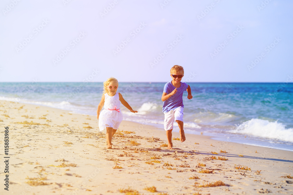 little boy and girl running at beach