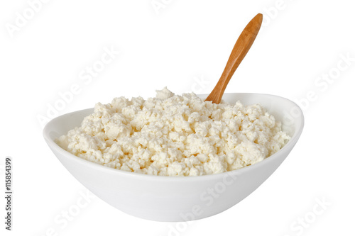 cottage cheese with the wooden spoon in a white bowl isolated on a white background - with clipping path