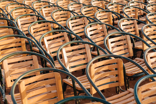 Wooden chairs. Empty stools without people. Concept photo - absence of audience.