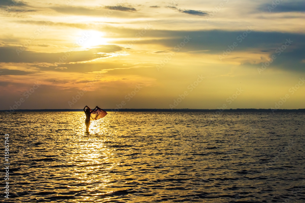 woman girl walking in the sea at sunset, dawn woman girl walking in the sea at sunset, dawn