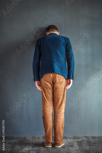 Quadro em tela Rear view of stressed man punching the wall