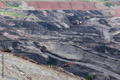 Part of a pit with big mining truck working photo