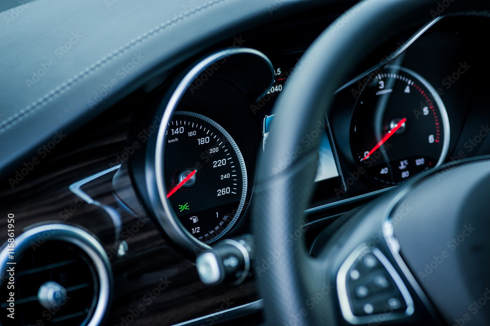 Luxury car interior details. Speedometer, steering wheell