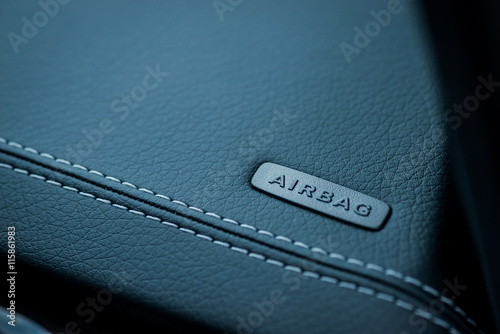 Fotografía Luxury car interior details. Airbag badge on leather dashboard