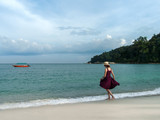 Young woman walking on a beautiful beach