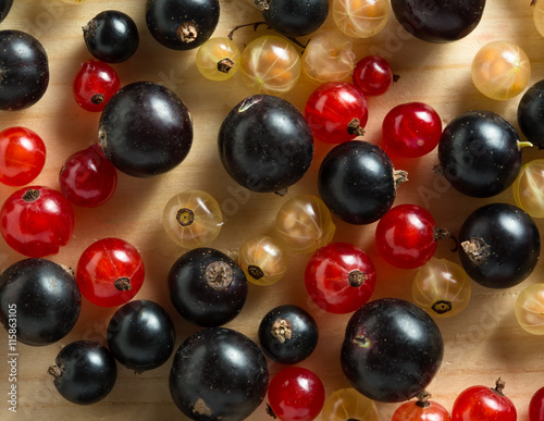 border of fresh berries mix on wooden tabletop