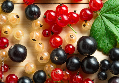 border of fresh berries mix on wooden tabletop