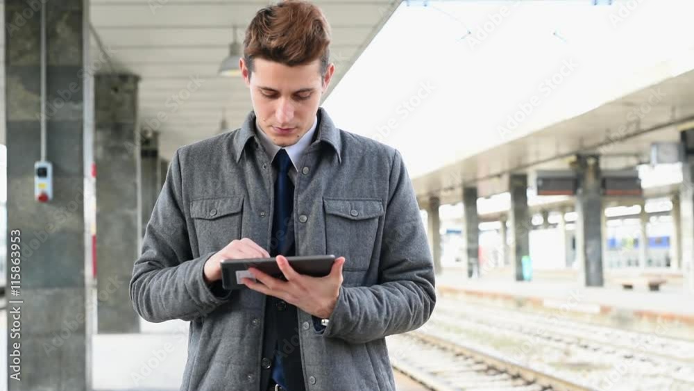 Using digital tablet at railroad platform