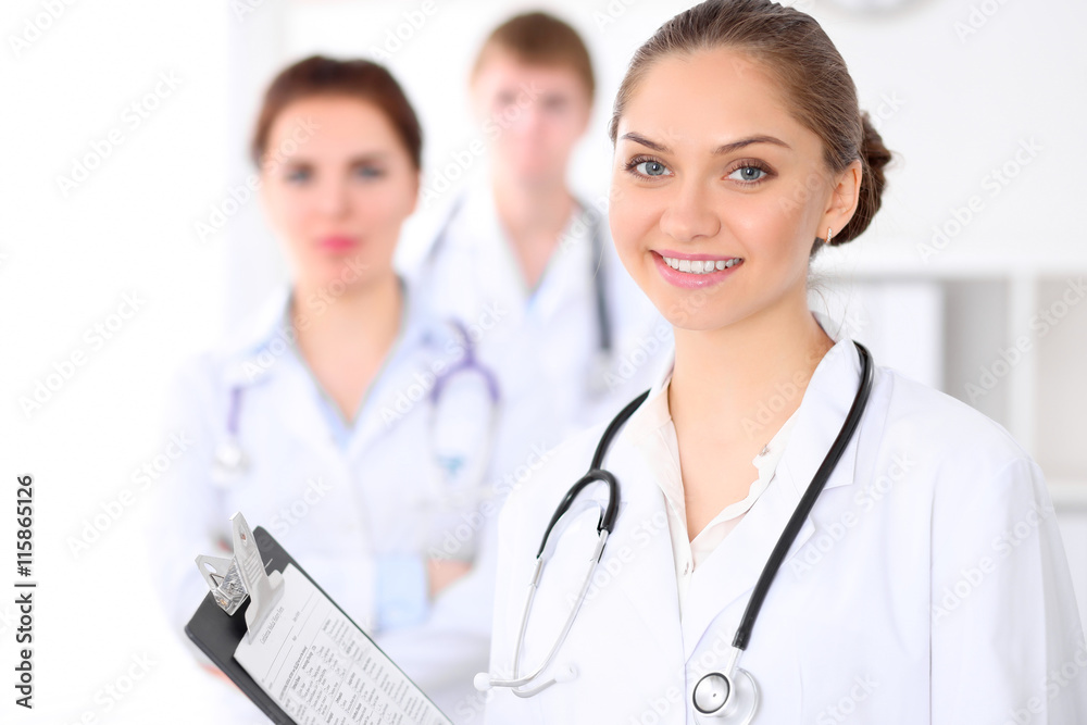 Happy doctor woman with medical staff at the hospital Happy doctor woman with medical staff at the hospital