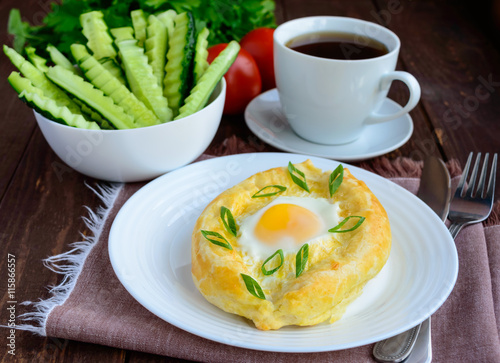 Khachapuri in Adjara (flat cakes with different fillings in the form of a boat) - the national dish of Georgian cuisine. And a cup of tea