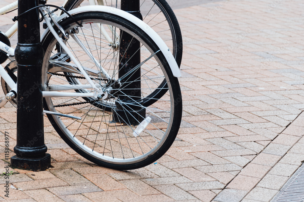 Bicycles wheels in a cobblestone pavement