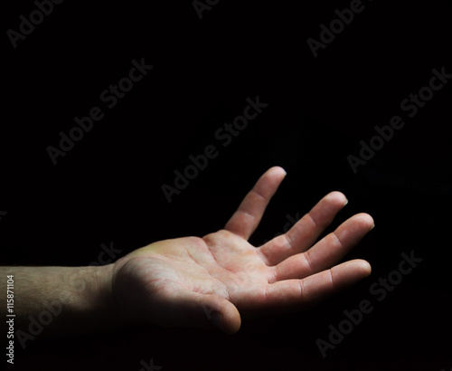 Businessman hand on black dark background