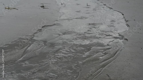 Trickling water seeping out of a tidal marsh towards the ocean at Fripp Island South Carolina, a string of islands near Beaufort consisting of Lady's, Hunting, and Fripp Islands photo