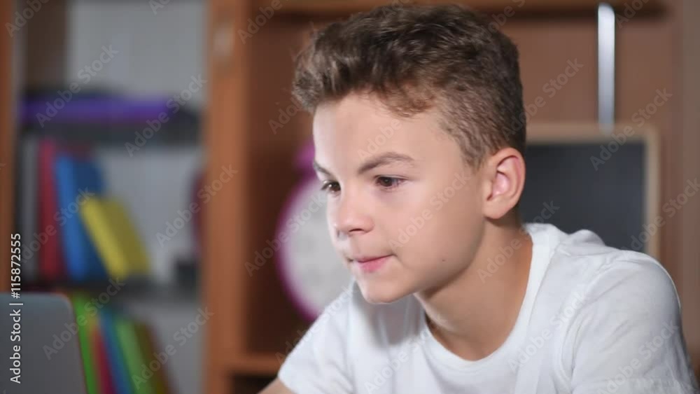 Teen boy working on laptop Teen boy working on laptop