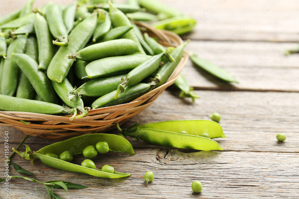 Green peas on a grey wooden table Green peas on a grey wooden table