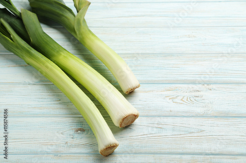 Green leeks on a blue wooden table