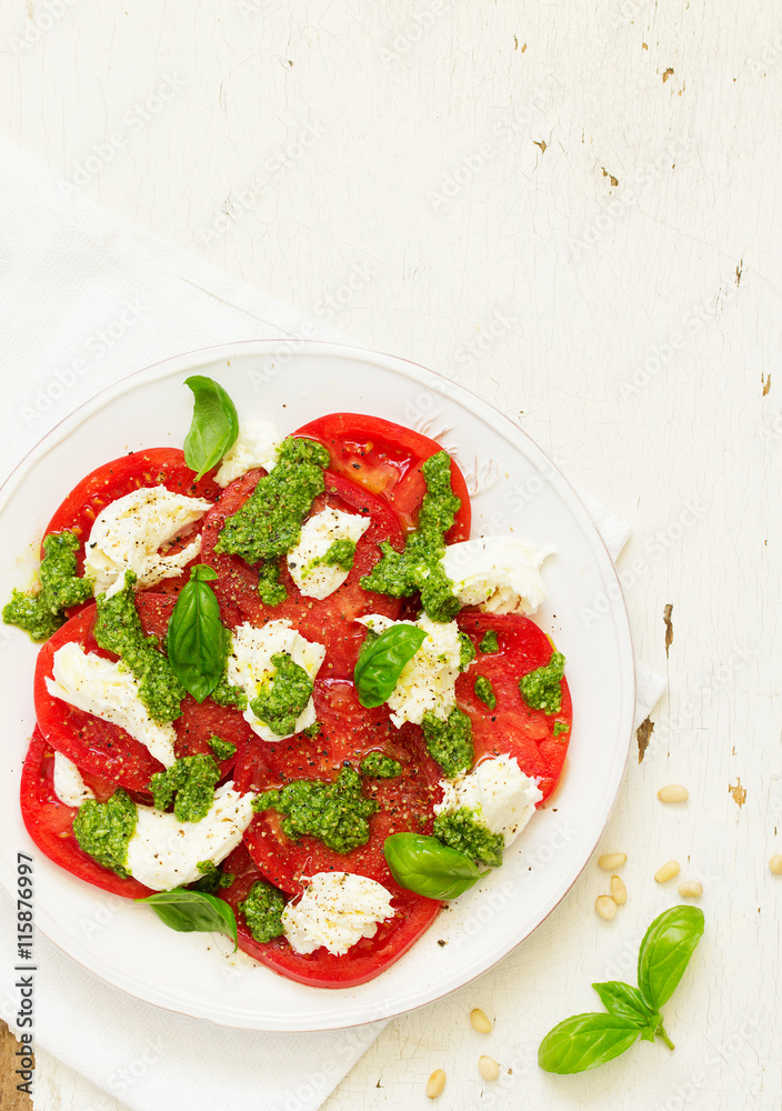 Delicious salad of tomato, mozzarella and pesto. Delicious salad of tomato, mozzarella and pesto.