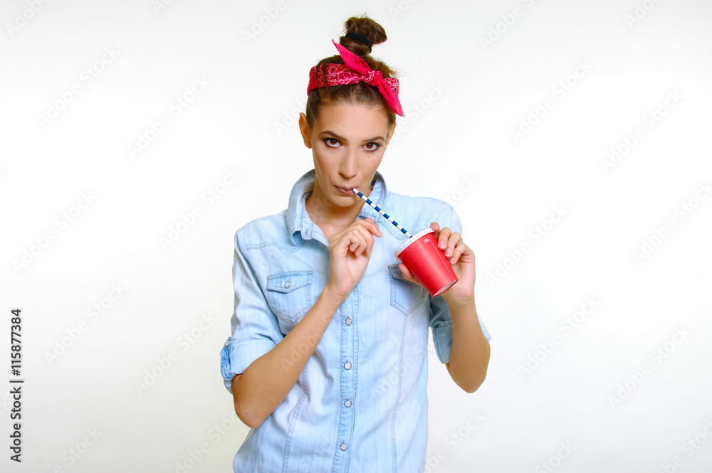 pin up retro style young woman drinking from red cup with straw