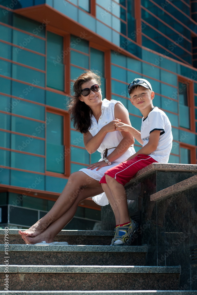 Mother and son near the building Mother and son near the building
