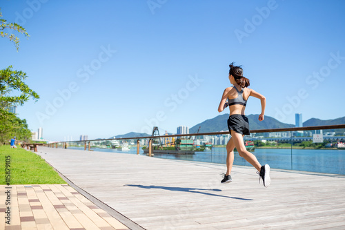 Back view of woman running in a city