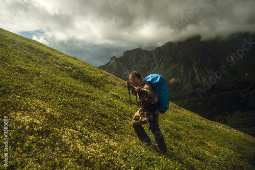 hiker climbing on top of the mountain