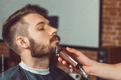 Fotografie Hipster client visiting barber shop