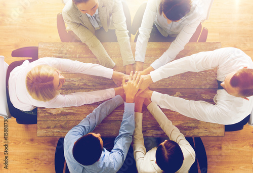 close up of business team with hands on top photo