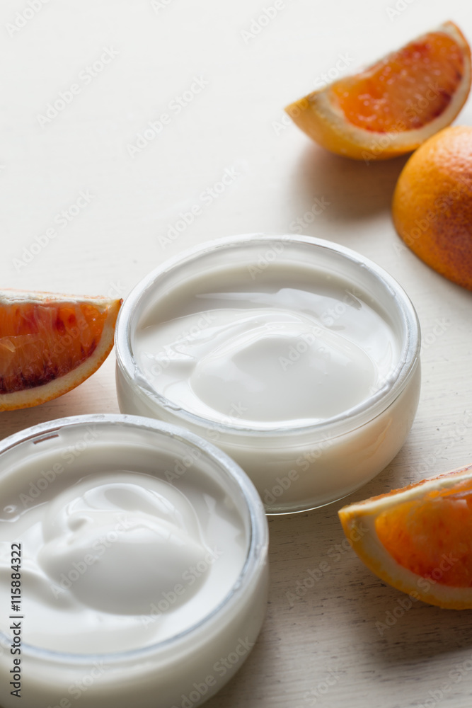 Yogurts or cosmetic cream assortment in glass jar on ligth background. Natural, healthy, gourmet dessert for granola breakfast. Sweet yoghurts closeup with copy space. Yogurts or cosmetic cream assortment in glass jar on ligth background. Natural, healthy, gourmet dessert for granola breakfast. Sweet yoghurts closeup with copy space.