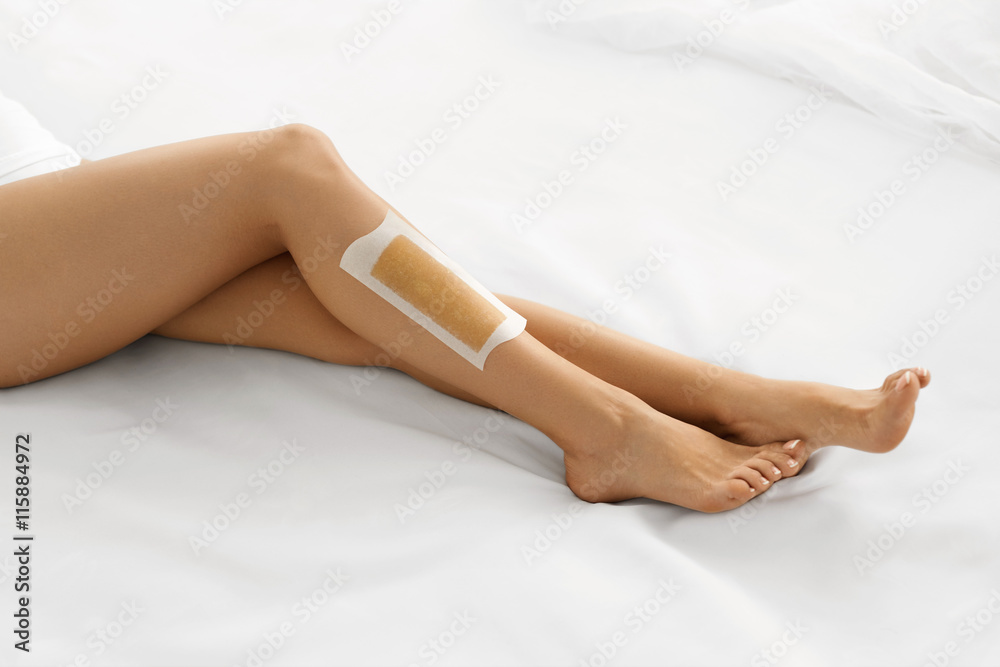 Fototapeta premium Body Care. Long Woman's Legs With Wax. Depilation Concept