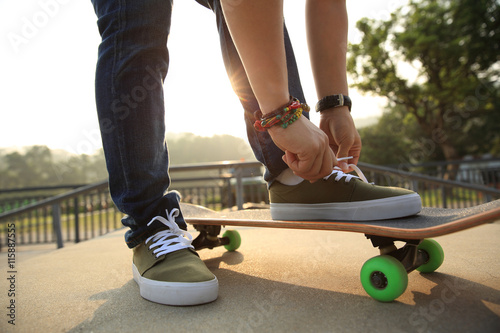 skateboarder tying shoelace outdoor