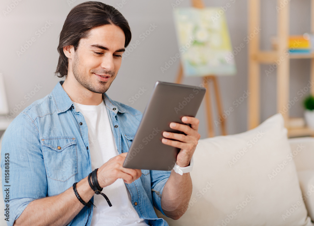Positive delighted man resting at home Positive delighted man resting at home