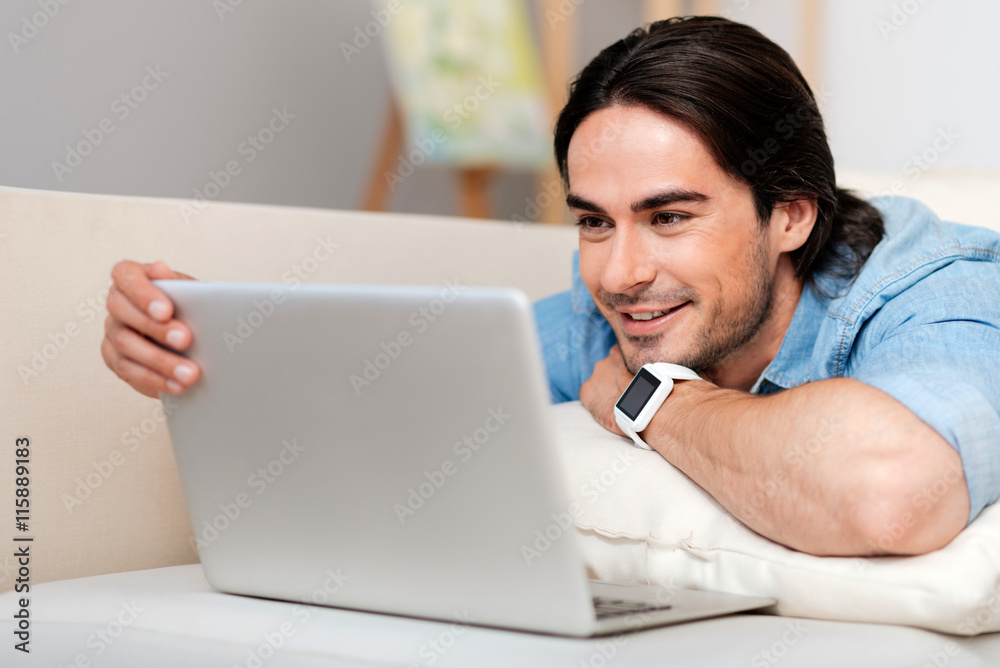 Positive bearded man using laptop Positive bearded man using laptop