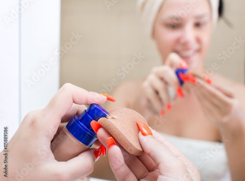 Girl applying primer for make up