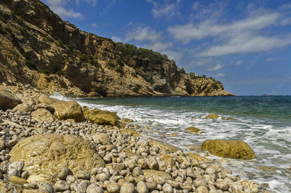 Waves crash against the boulders on the balearic islands.
Spain,Ibiza,Summer