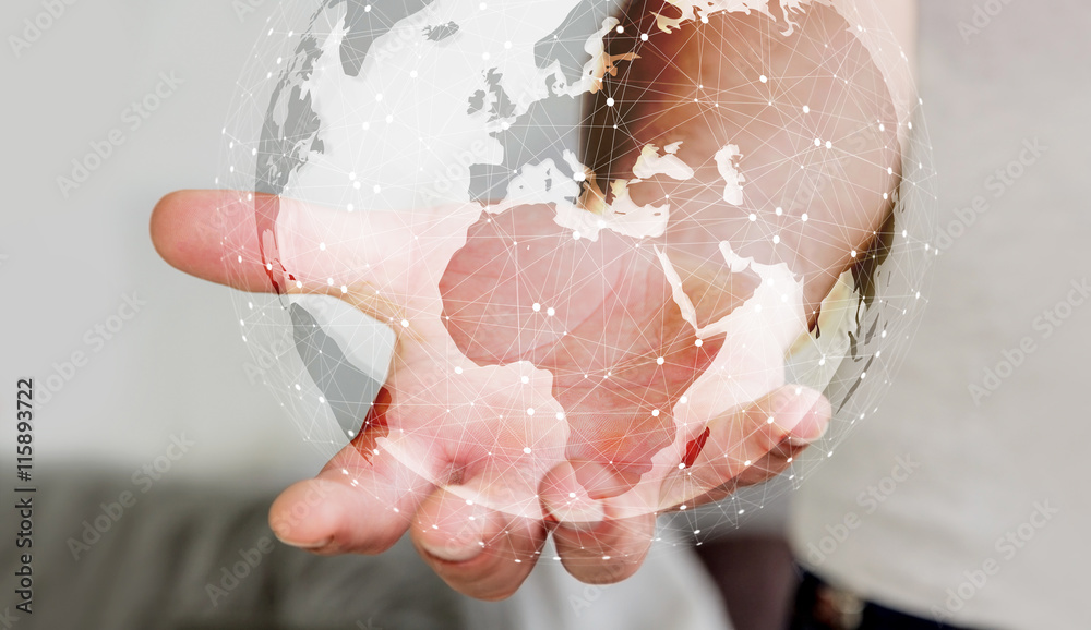 Fototapeta premium Businessman using digital tactile world interface with his hand