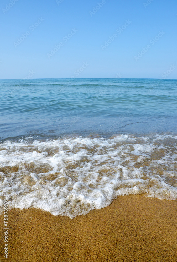 Blue sea with sandy beach in sunny day.