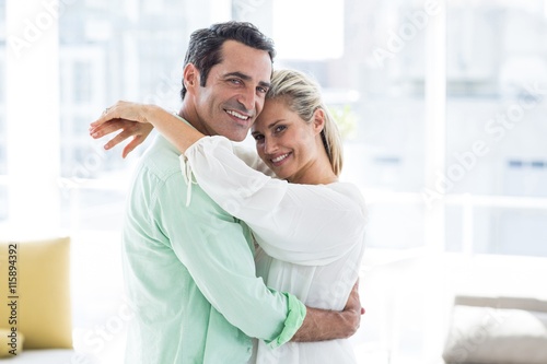 Portrait of mid adult couple hugging at home © WavebreakMediaMicro