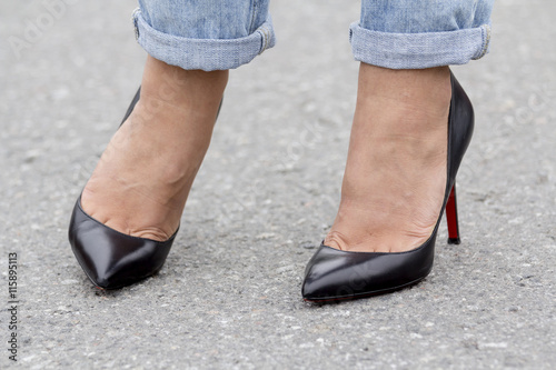 Feet girl in fashionable footwear, close-up on the road © sergeizubkov64