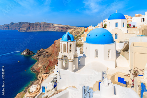 View of famous Oia village with blue domes of church buildings, Santorini island, Greece
