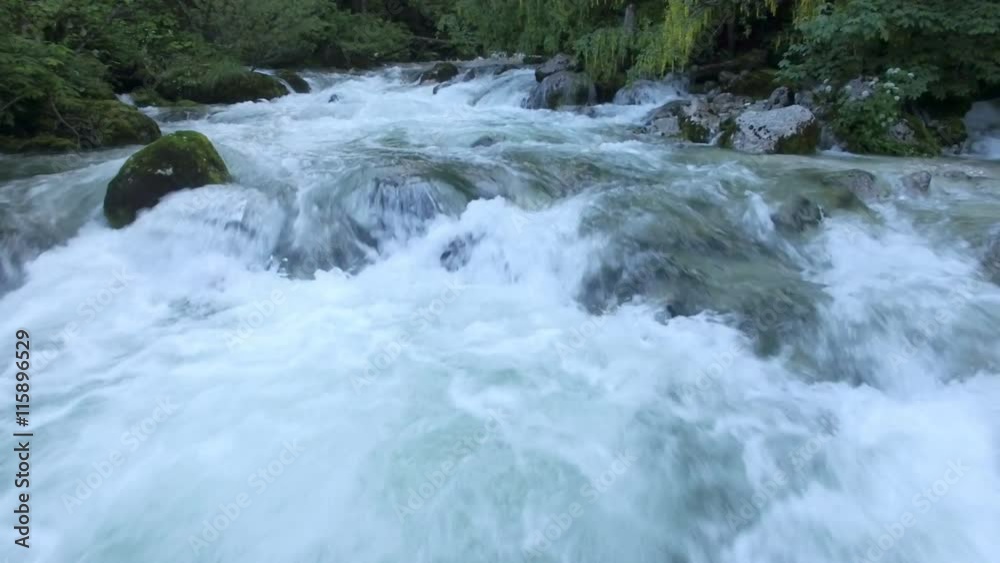 AERIAL: flight over the surface of a mountain river AERIAL: flight over the surface of a mountain river