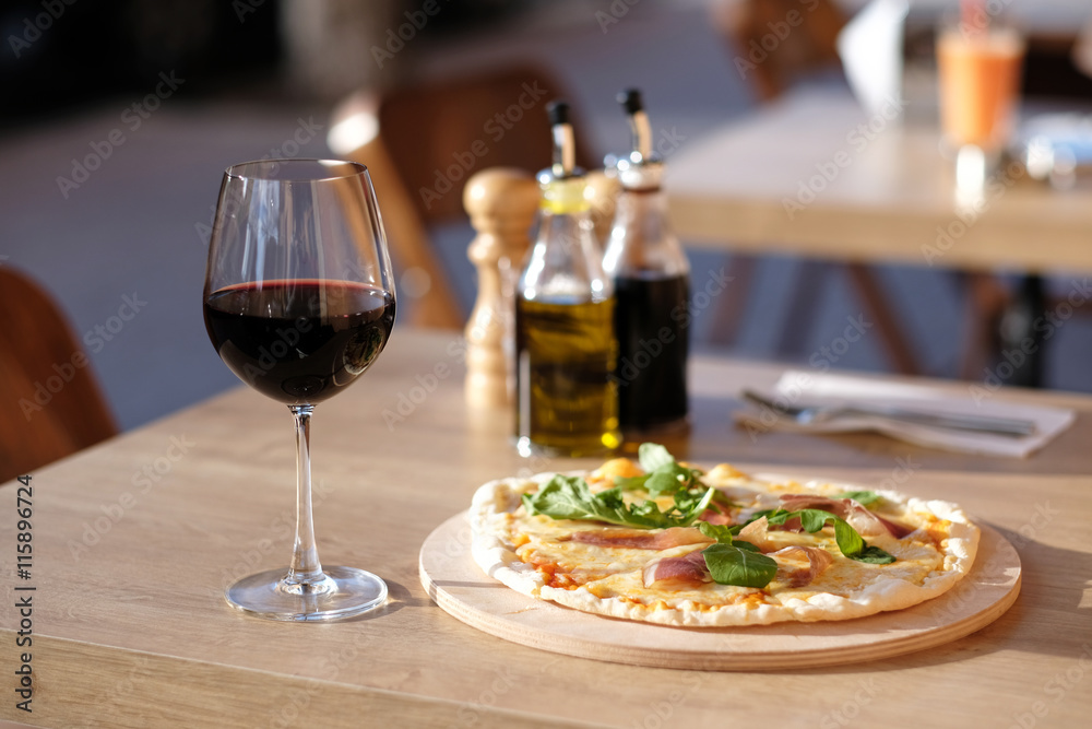 Pizza and red wine in restaurant