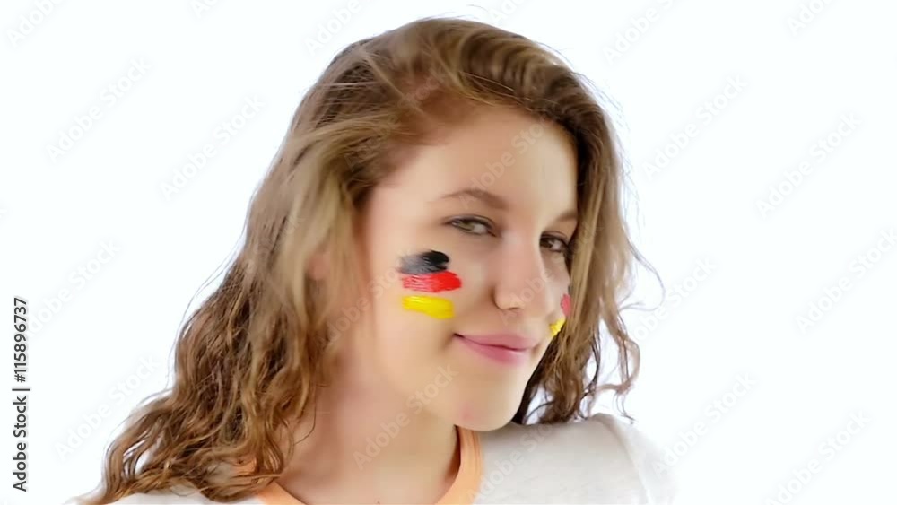 Girl with German flag on her face smiling at the camera, slow motion Girl with German flag on her face smiling at the camera, slow motion