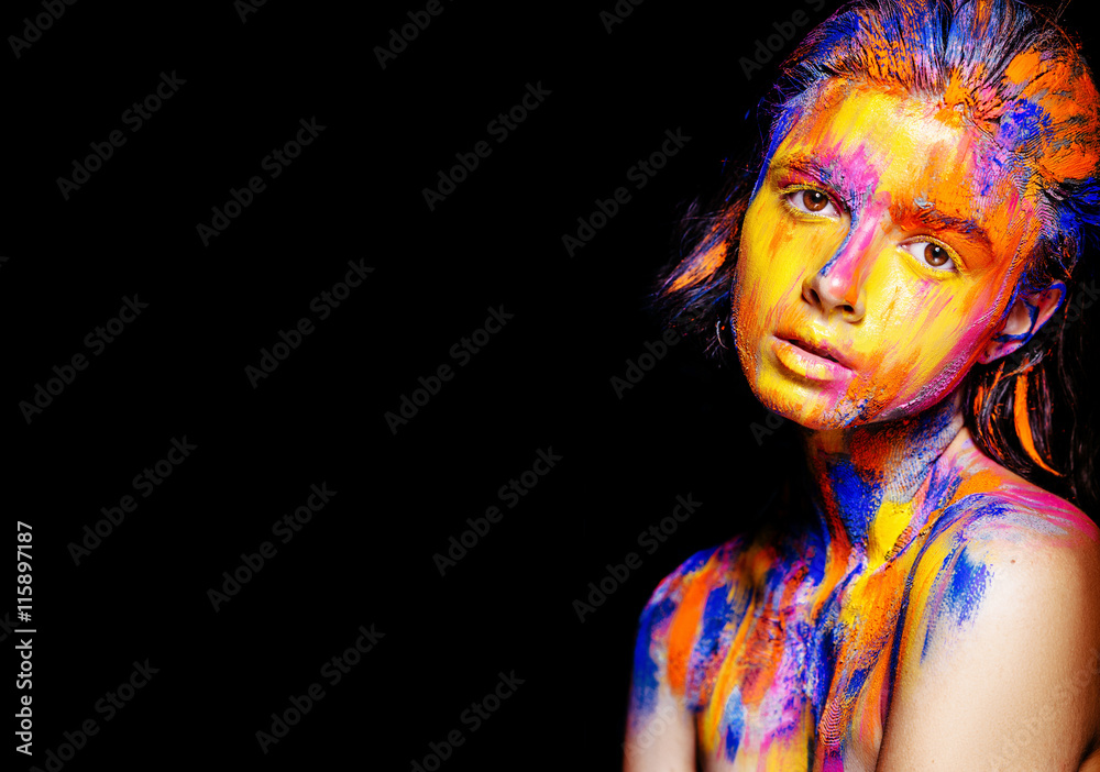 Naklejka premium Art makeup. Face, neck and hair girls smeared with bright colors of yellow, blue and pink colors. Holi Festival