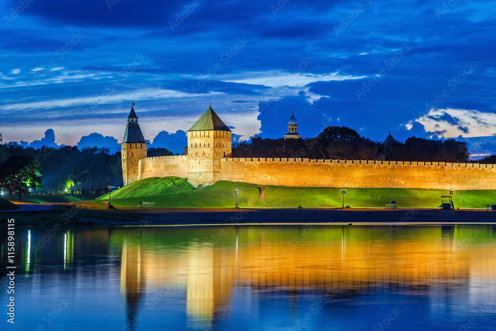 Wall and towers of Novgorod Veliky kremlin, view from opposite side of river Volkhov, Russia