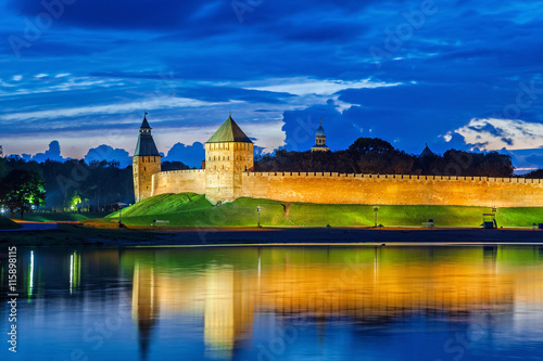 Wall and towers of Novgorod Veliky kremlin, view from opposite side of river Volkhov, Russia