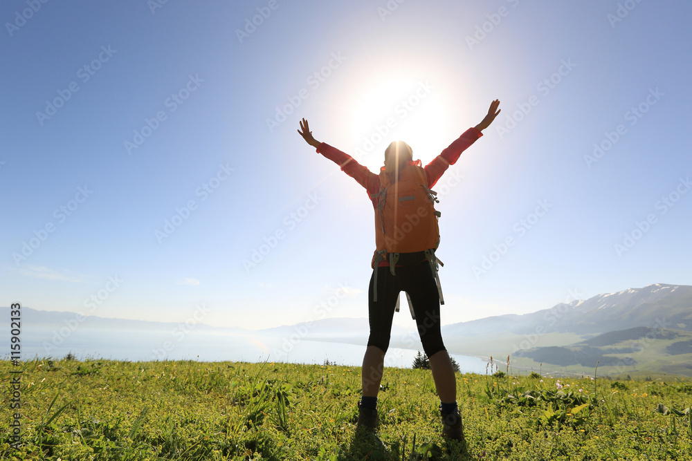 cheering successful woman backpacker open arms on mountain peak cheering successful woman backpacker open arms on mountain peak