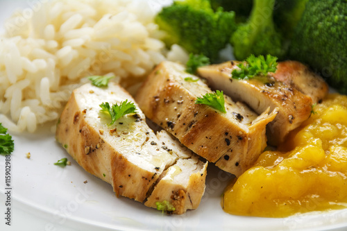chicken breast fillet with fruity mango chuntey, broccoli and rice, closeup